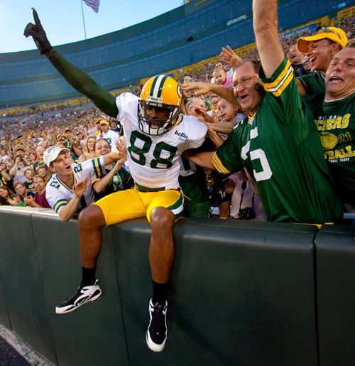 Jermichael Finley celebrates a touchdown with a Lambeau Leap.