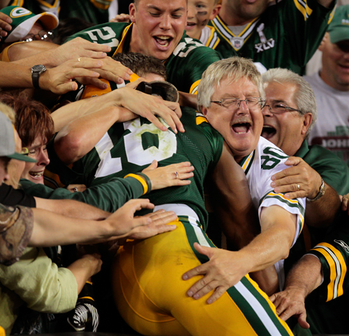 Green Bay Packers Randall Cobb does a Lambeau leap after scoring a touchdown on a 108 yard kickoff return.