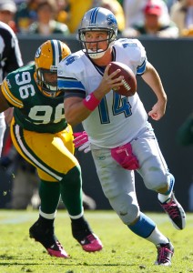Detroit Lions quarterback Shaun Hill tries to elude the defensive pressure of Green Bay Packers defensive end Mike Neal.