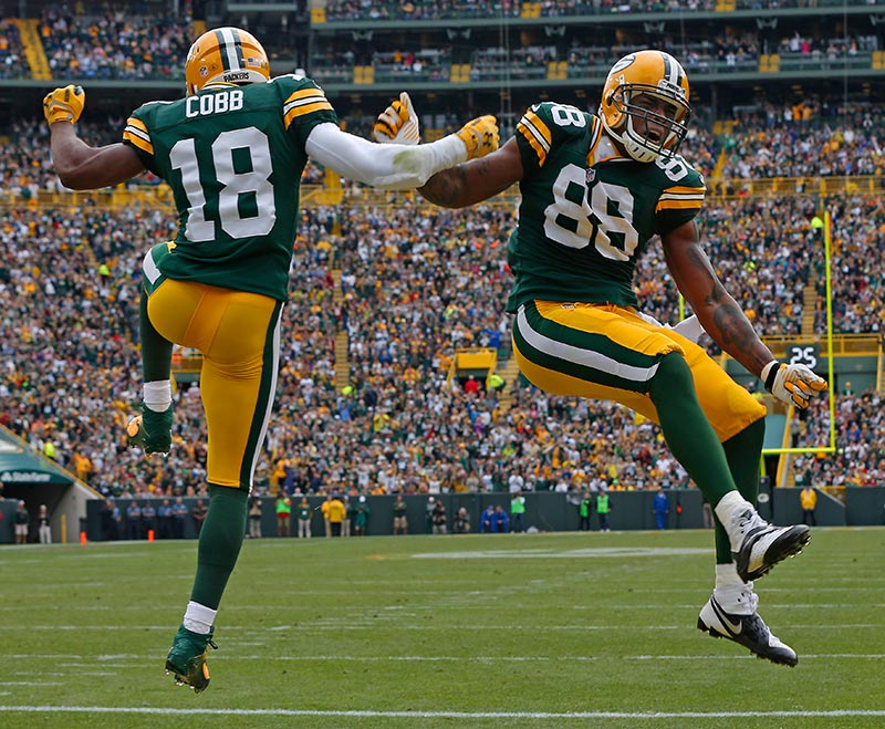 Green Bay Packers wide receiver Randall Cobb helps tight end Jermichael Fin...